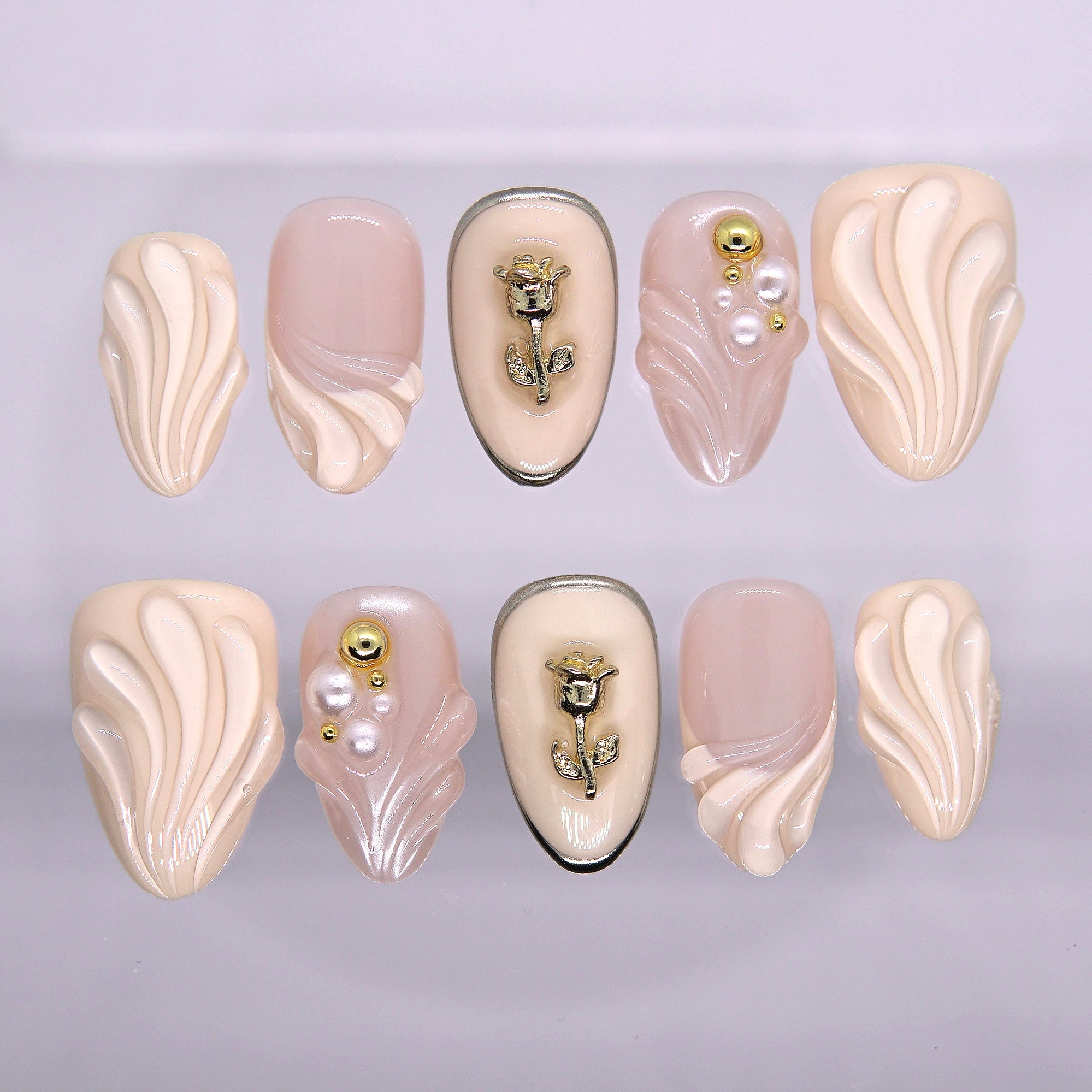 Rosewater Shell nude press-on nails with 3D sculpted shell texture, pearl accents, and gold rose charm from Art By Cloe Earth · Calm series.