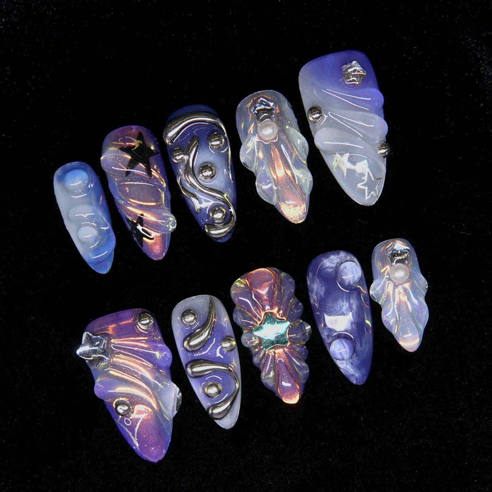 Close-up of sculpted chrome waves and opal-like embellishments.