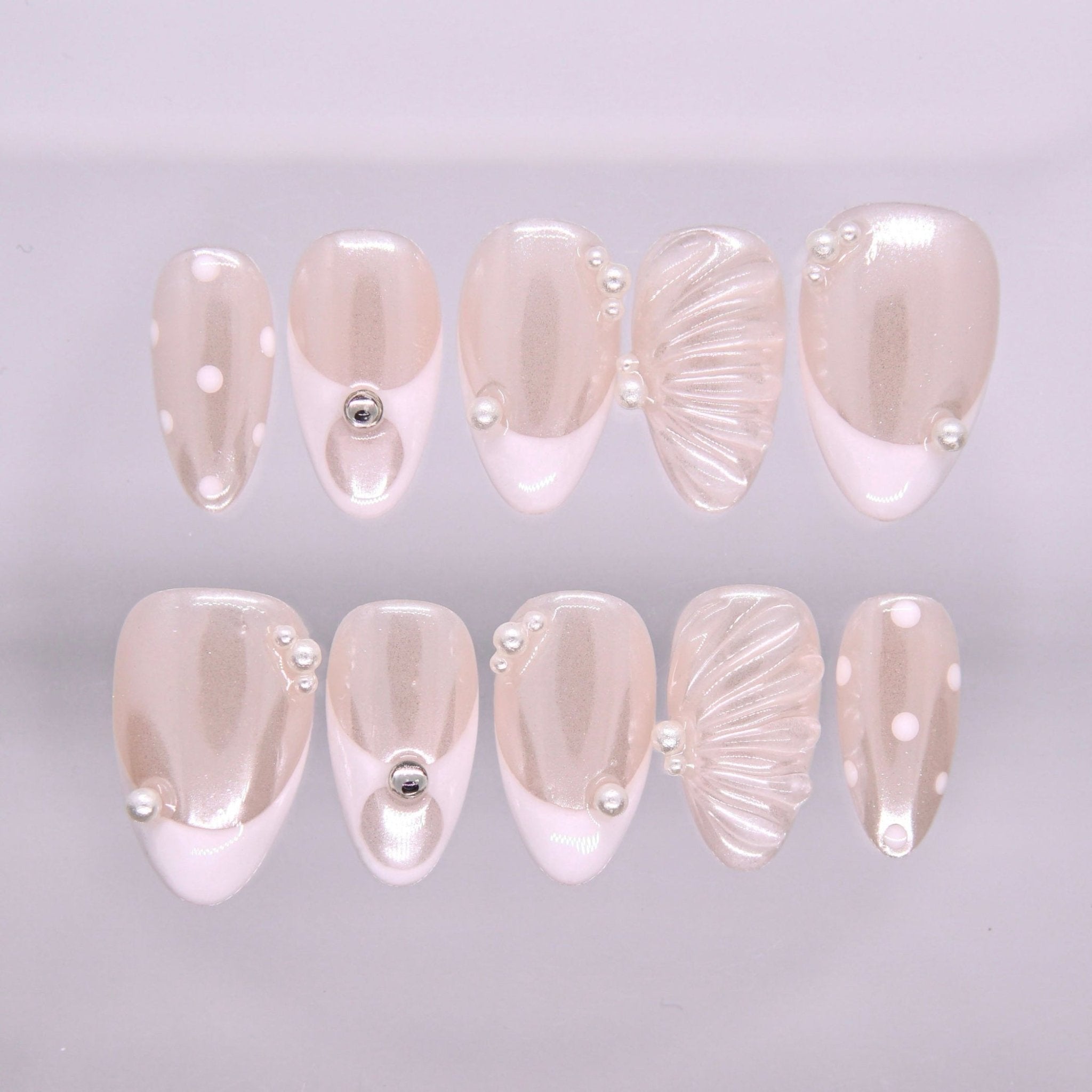 Begin with Grace press-on nails set featuring sheer nude tones with pearl accents and elegant minimalist design