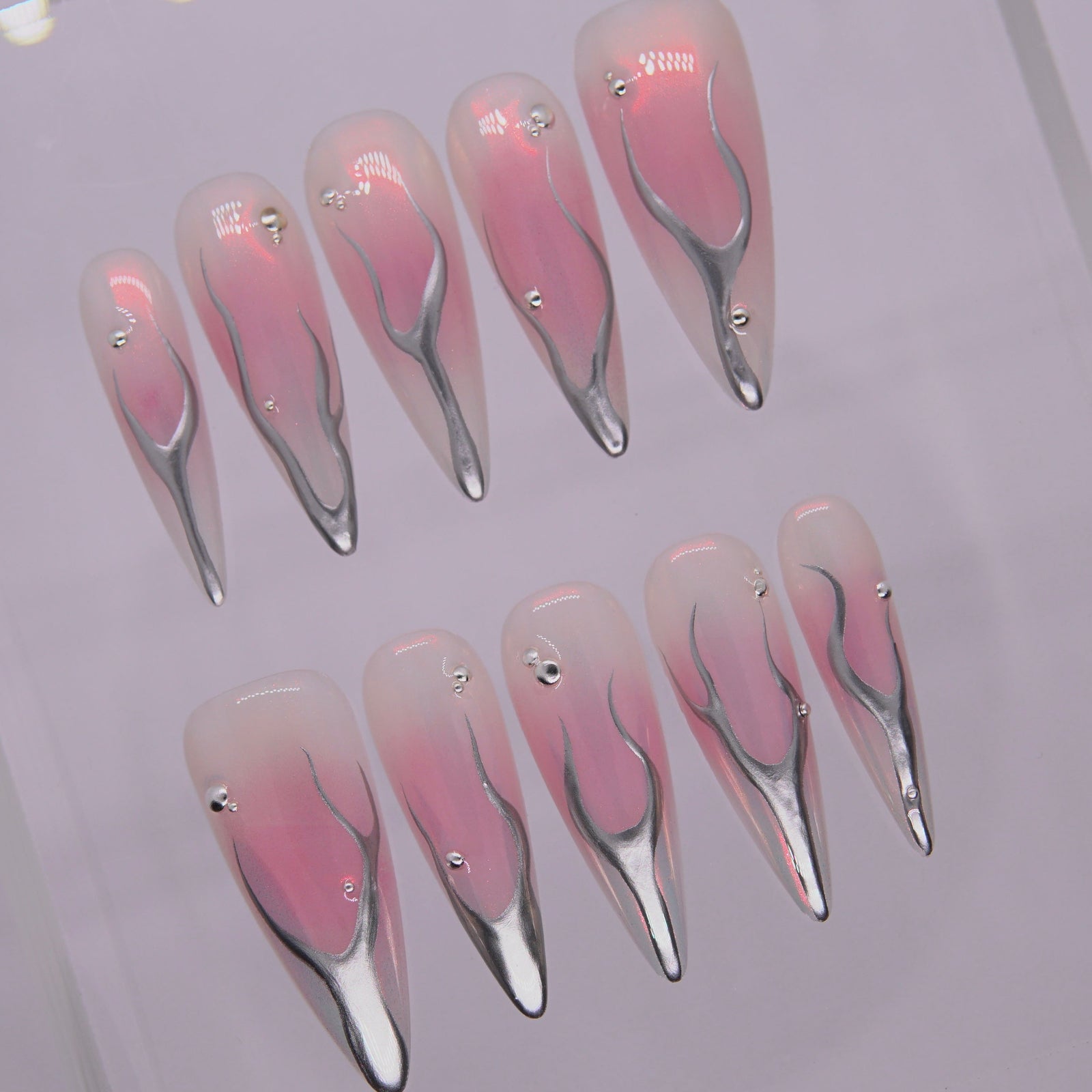 Close-up of the flowing chrome texture and light reflection.