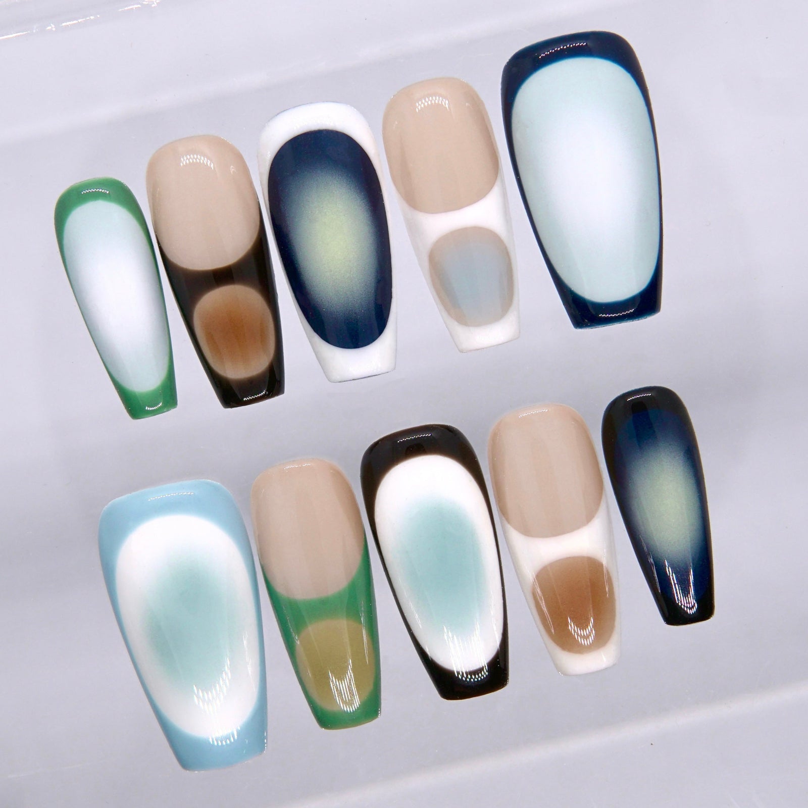 Close-up of glossy long square press on nails featuring cool-toned geometric framing, soft blurred centers, and modern abstract contrast
