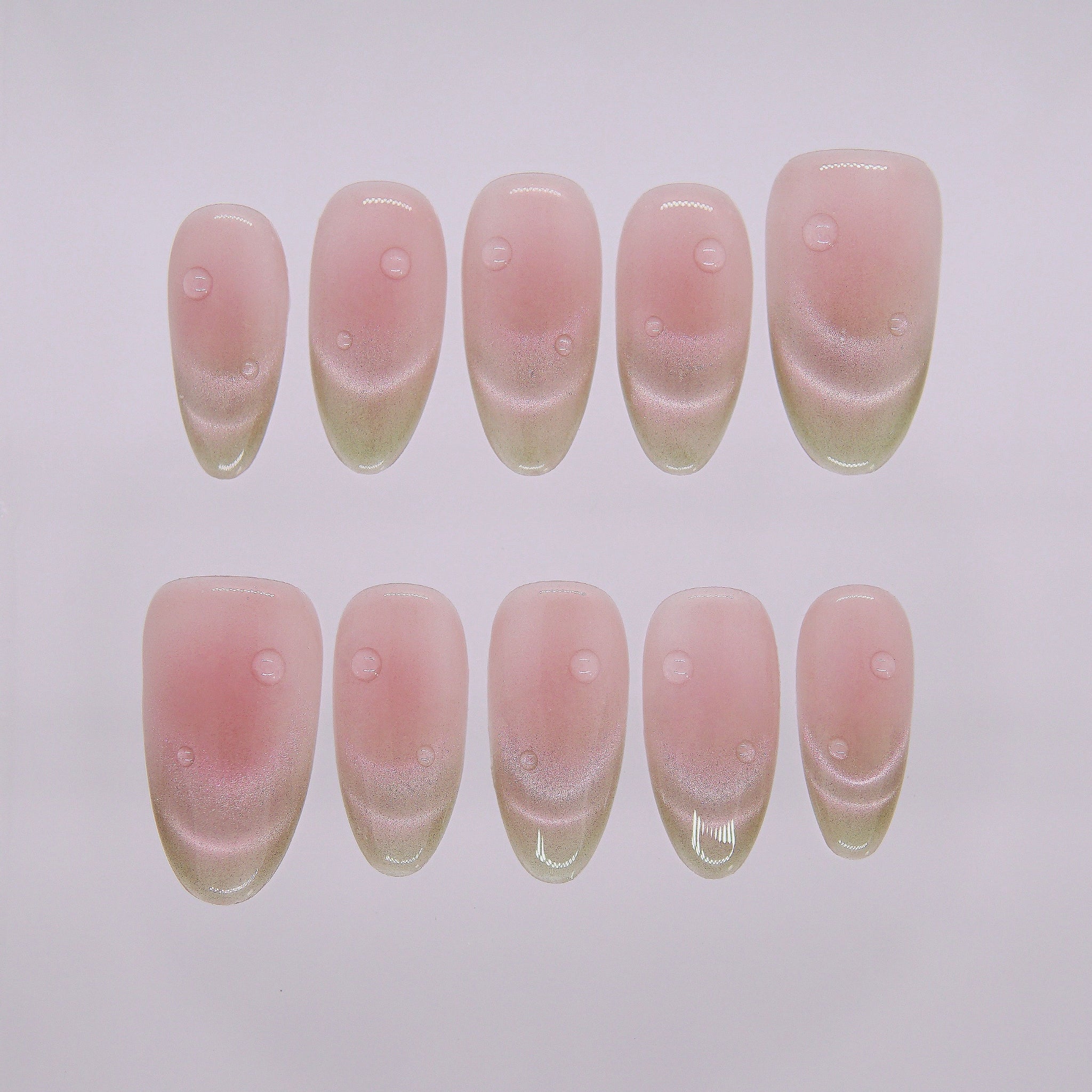 Mature Guava press-on nails in long oval shape with deep guava red to green gradient and glassy dewdrop accents from Nailsium’s Wood · Bloom collection.