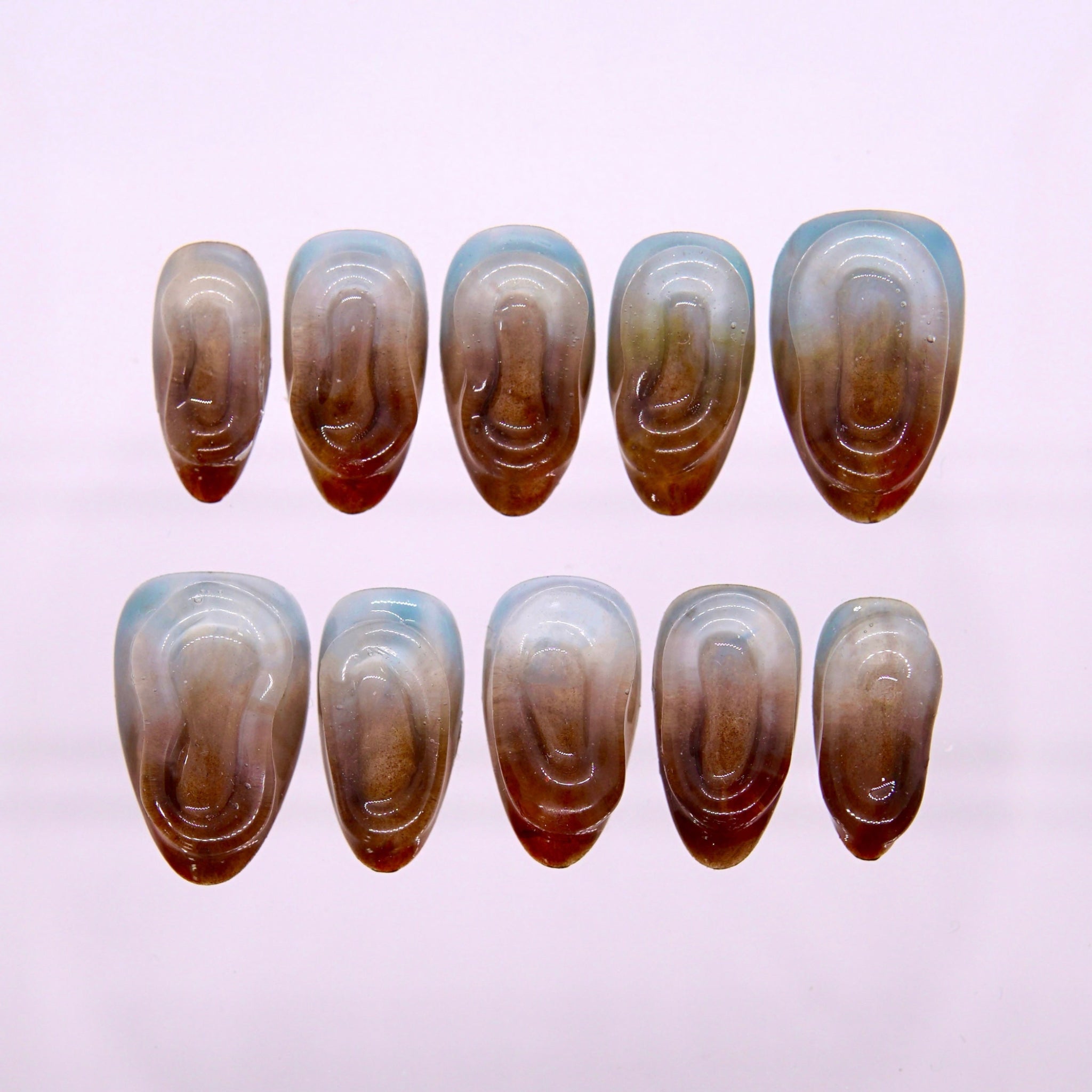 Ice Espresso press-on nails with iced latte gradient and ripple texture, displayed on neutral background.