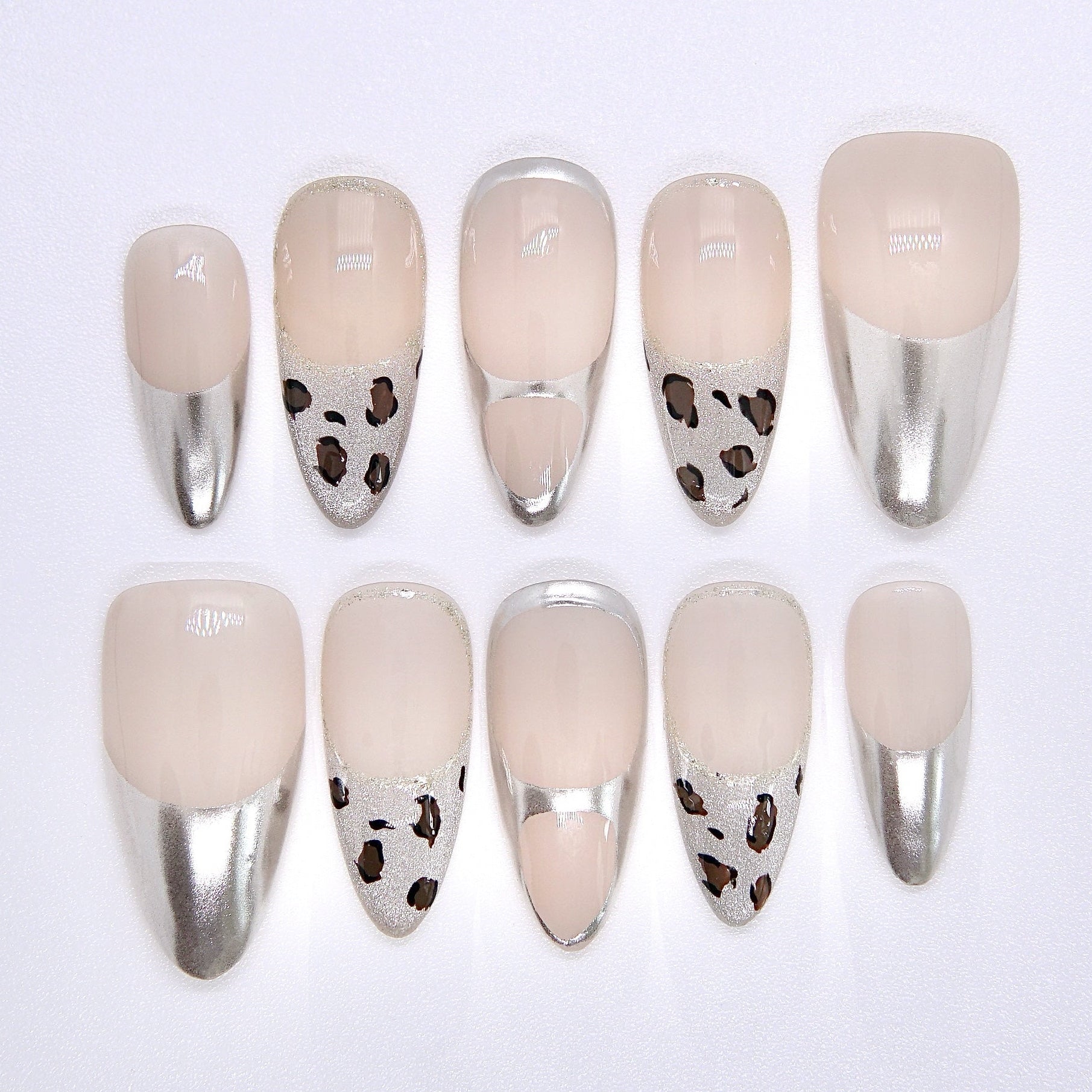 chrome silver and beige press-on nail set with cow-print accents – medium almond shape
