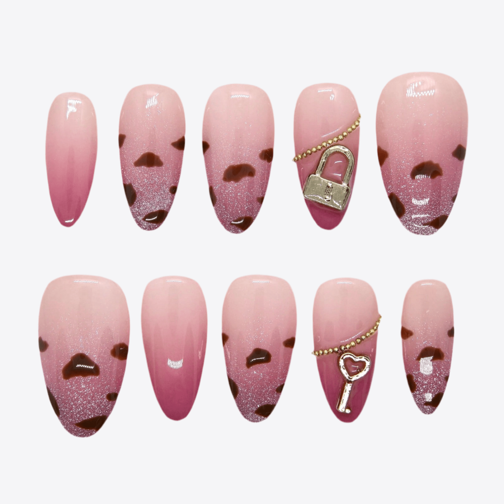 Glossy pink press-on nails with leopard tips, lock and key charms – full layout