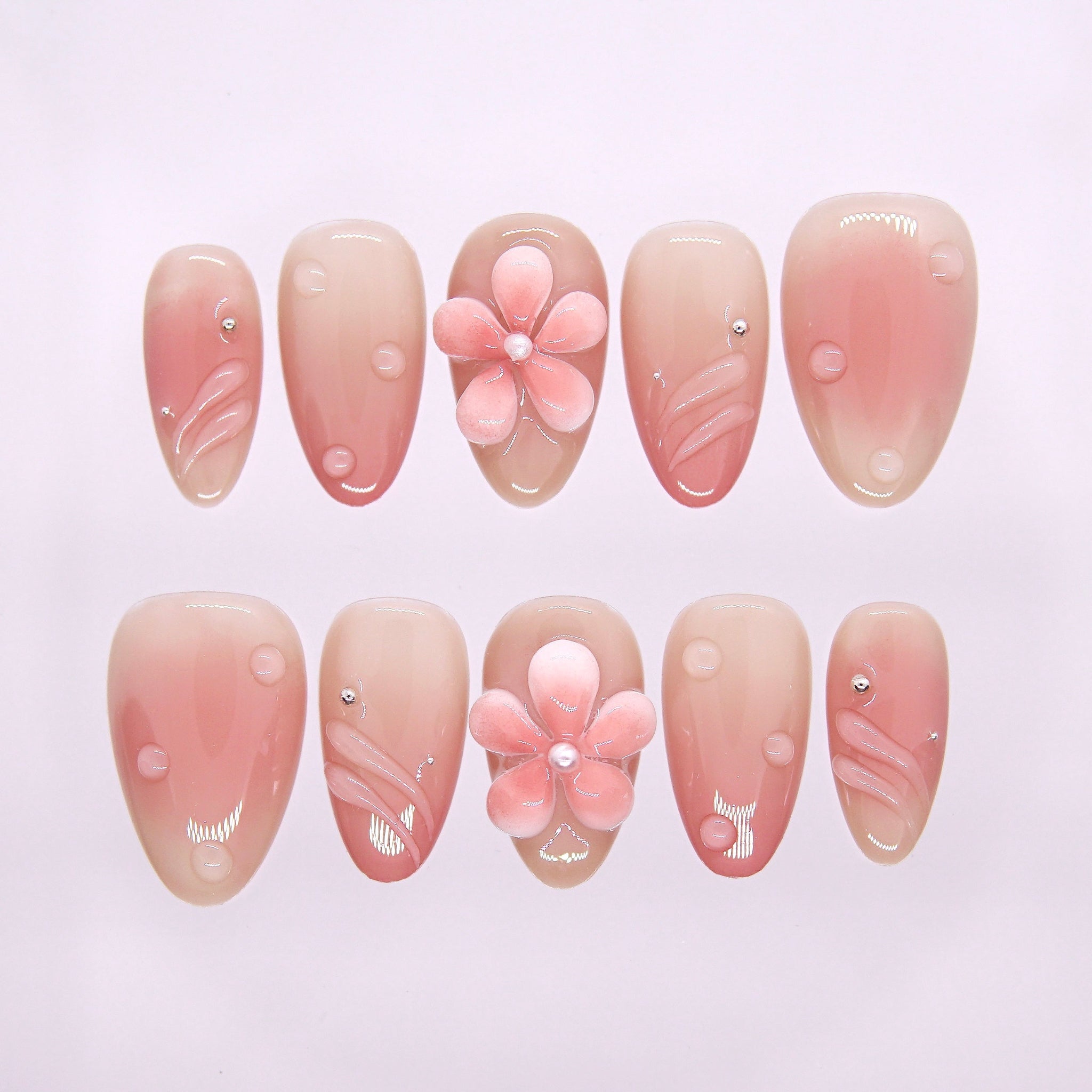 Morning Dew press-on nails with nude-pink gradient, pearl-centered flower, and dew-drop accents – soft Earth · Calm design by Art By Cloe.