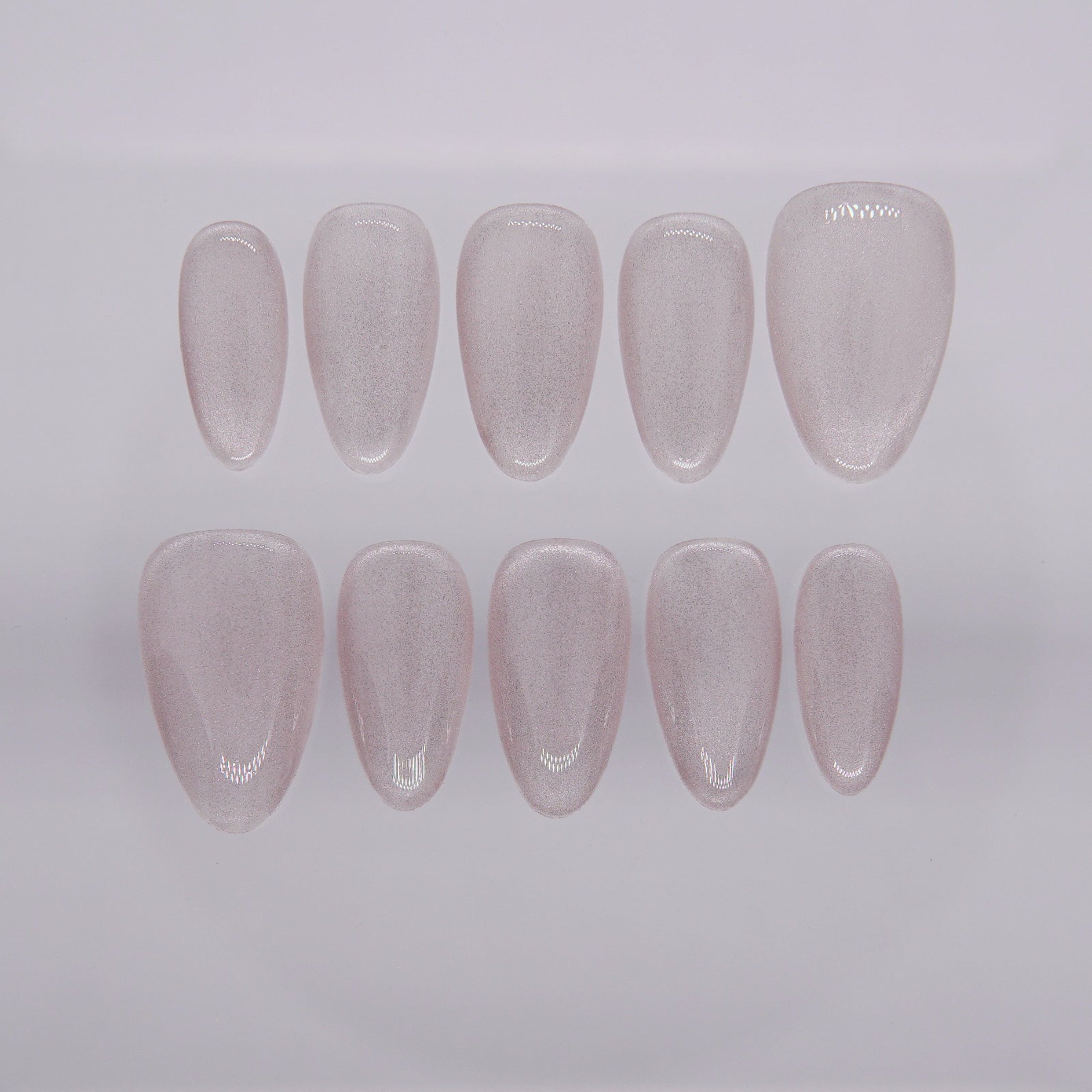 Close-up of silver cat eye press-on nails from Nailsium’s Silver Focus set, shown on clean white background.