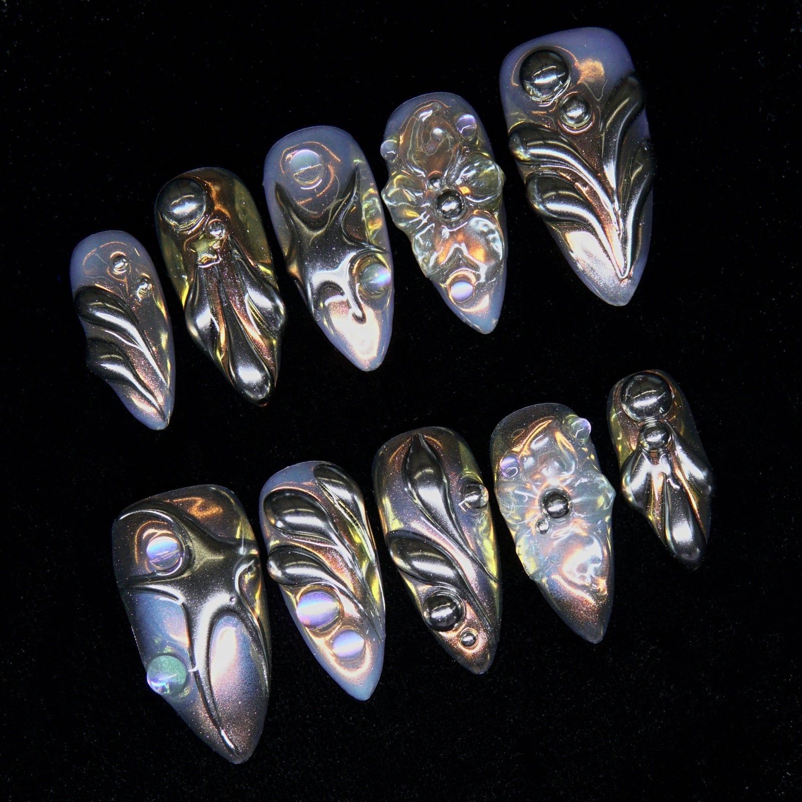 Close-up of hand-sculpted resin-like chrome details with amber highlights.