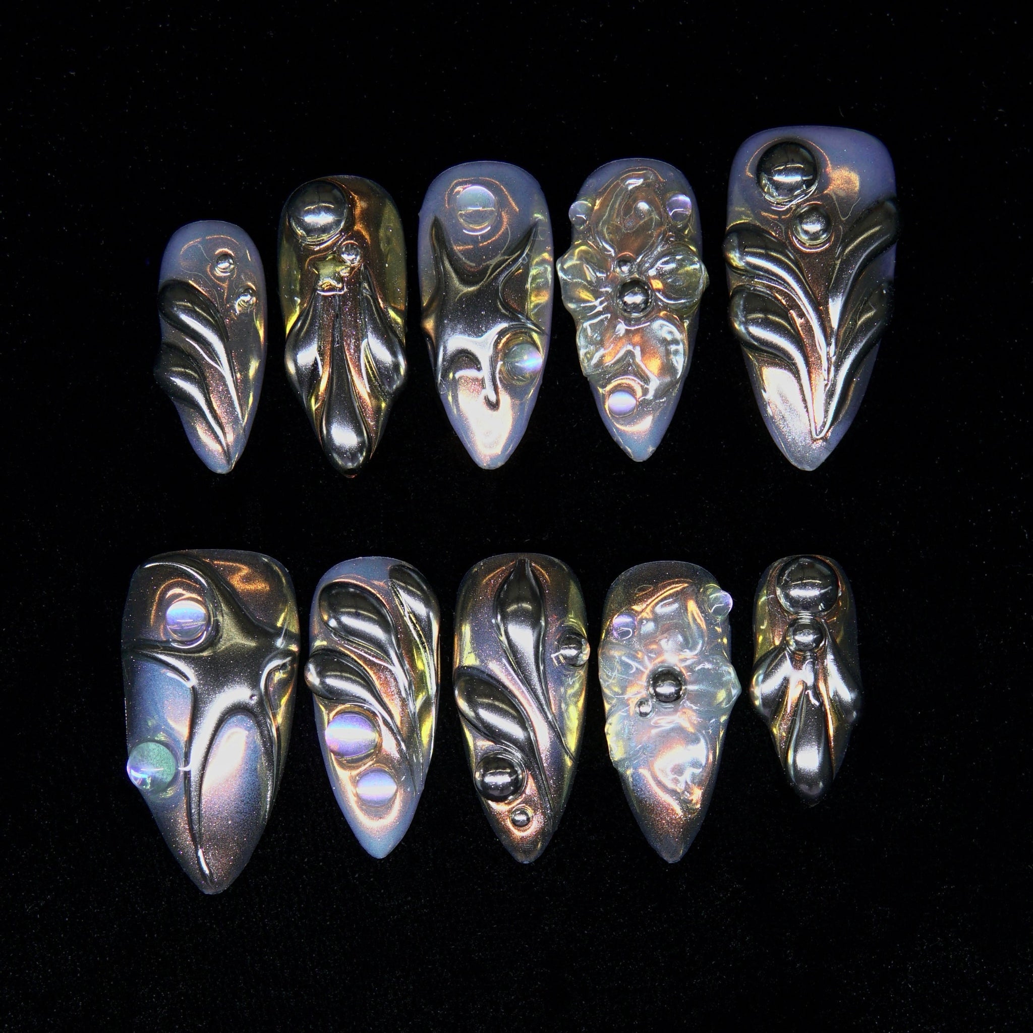 Solar Resin press-on nails — golden molten chrome texture with iridescent sheen.