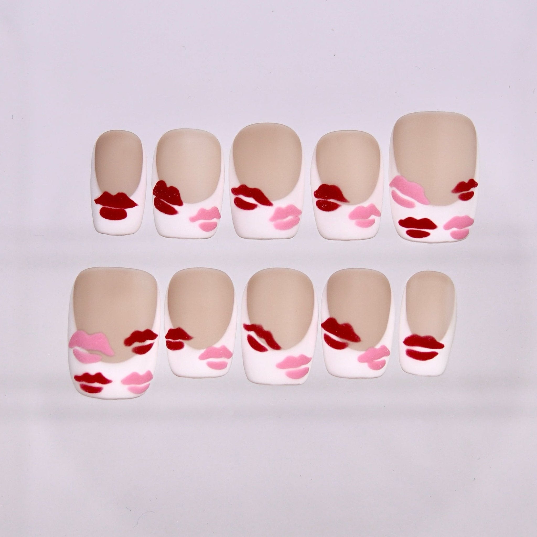 Monkey zodiac press-on nails in nude matte tones with red and pink lip designs, symbolizing sparkle and joyful self expression.