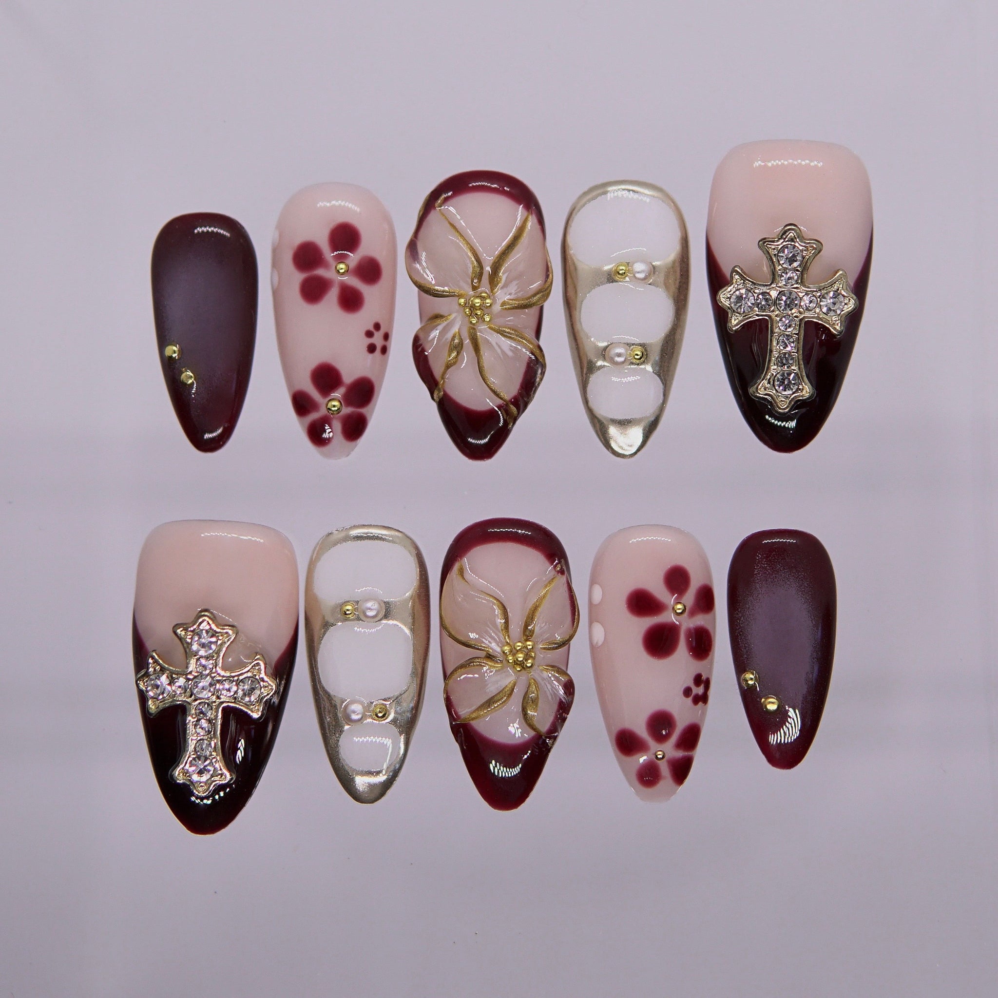 burgundy and nude cross-themed press-on nails with floral 3D design