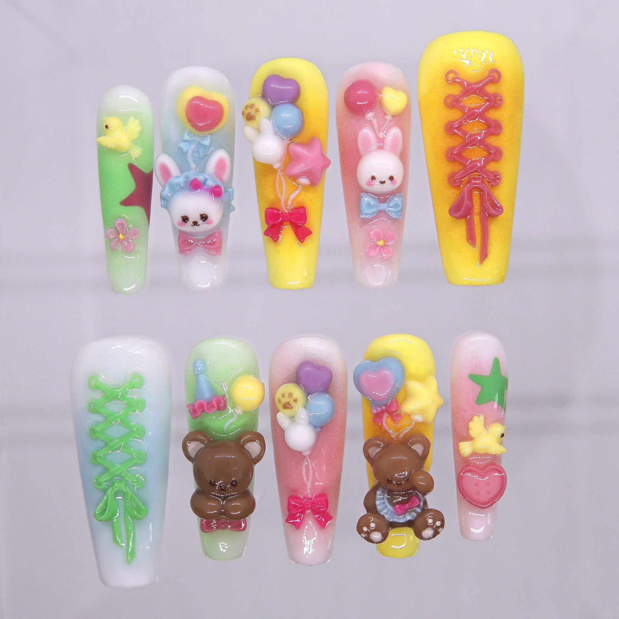 Toy Parade press-on nails with 3D bunnies, bears, balloons, and candy pastel stars – playful Wood · Bloom design by Nailsium.