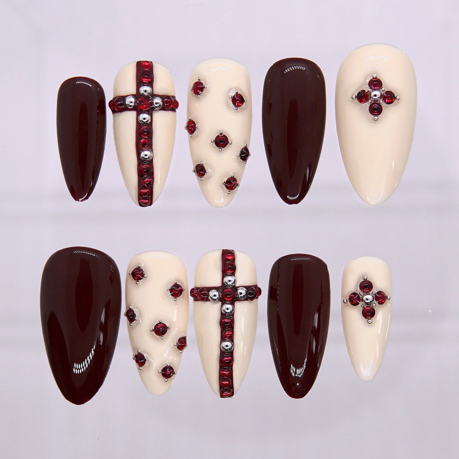 Wine & Worship press-on nails with ruby gems and cross designs on almond tips